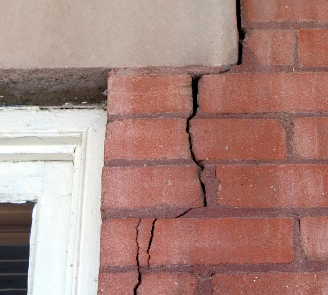 crack in brick siding of house